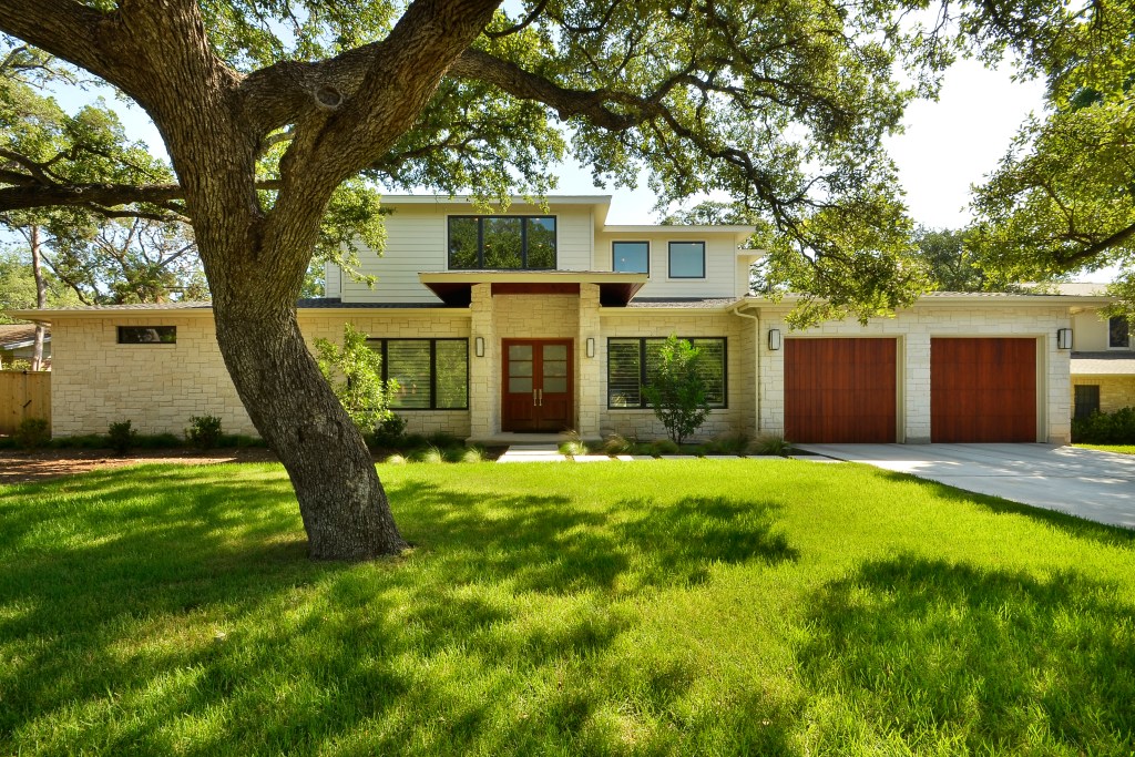 Large leafy tree in a home's front yard provides shade