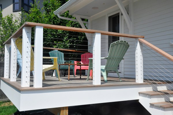 Colorful Adirondack chairs on a white deck