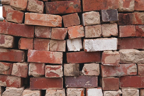 Stack of weathered red bricks