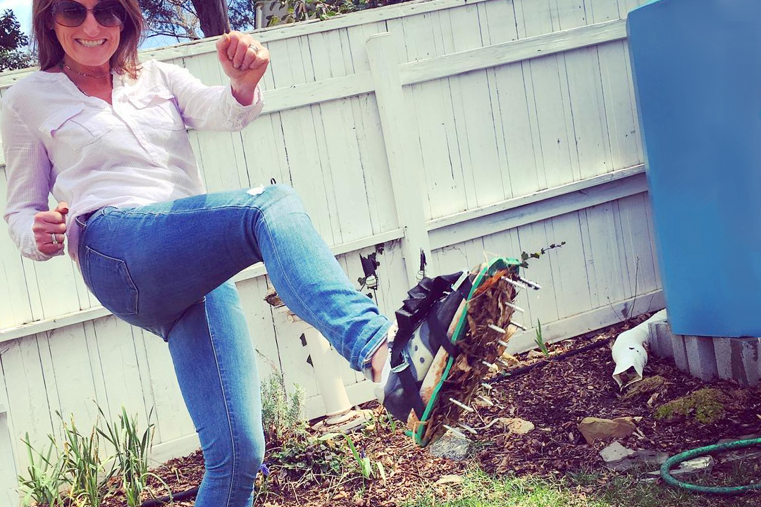 Woman aerating her lawn in spring