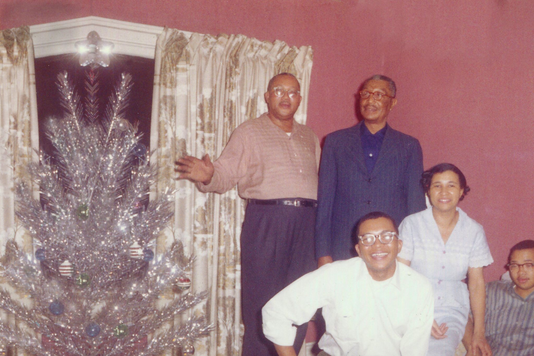 Vintage photo of a family next to the Christmas tree