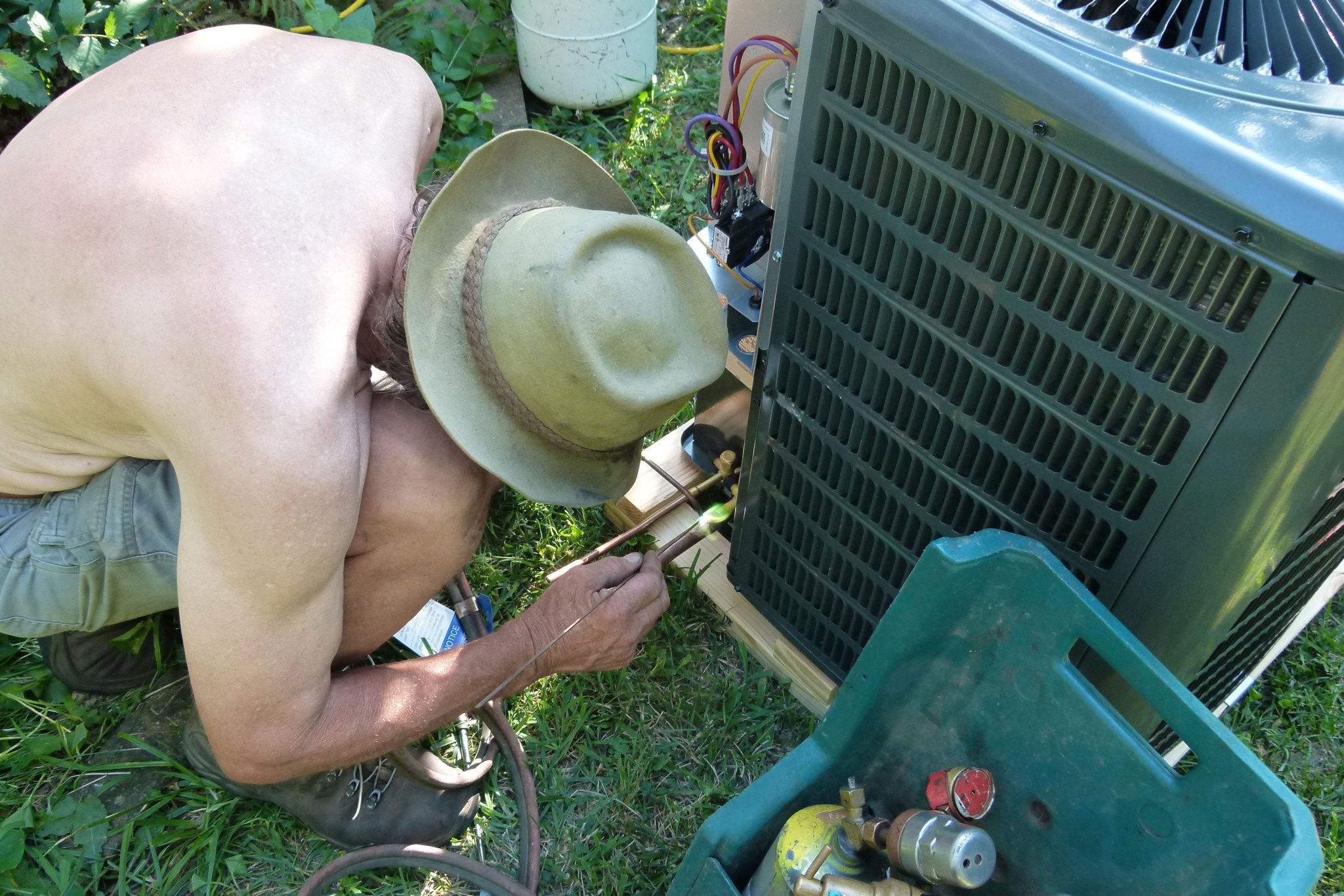 Fixing a home air conditioner on a hot day