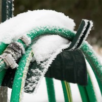 Frozen garden hose outside a house