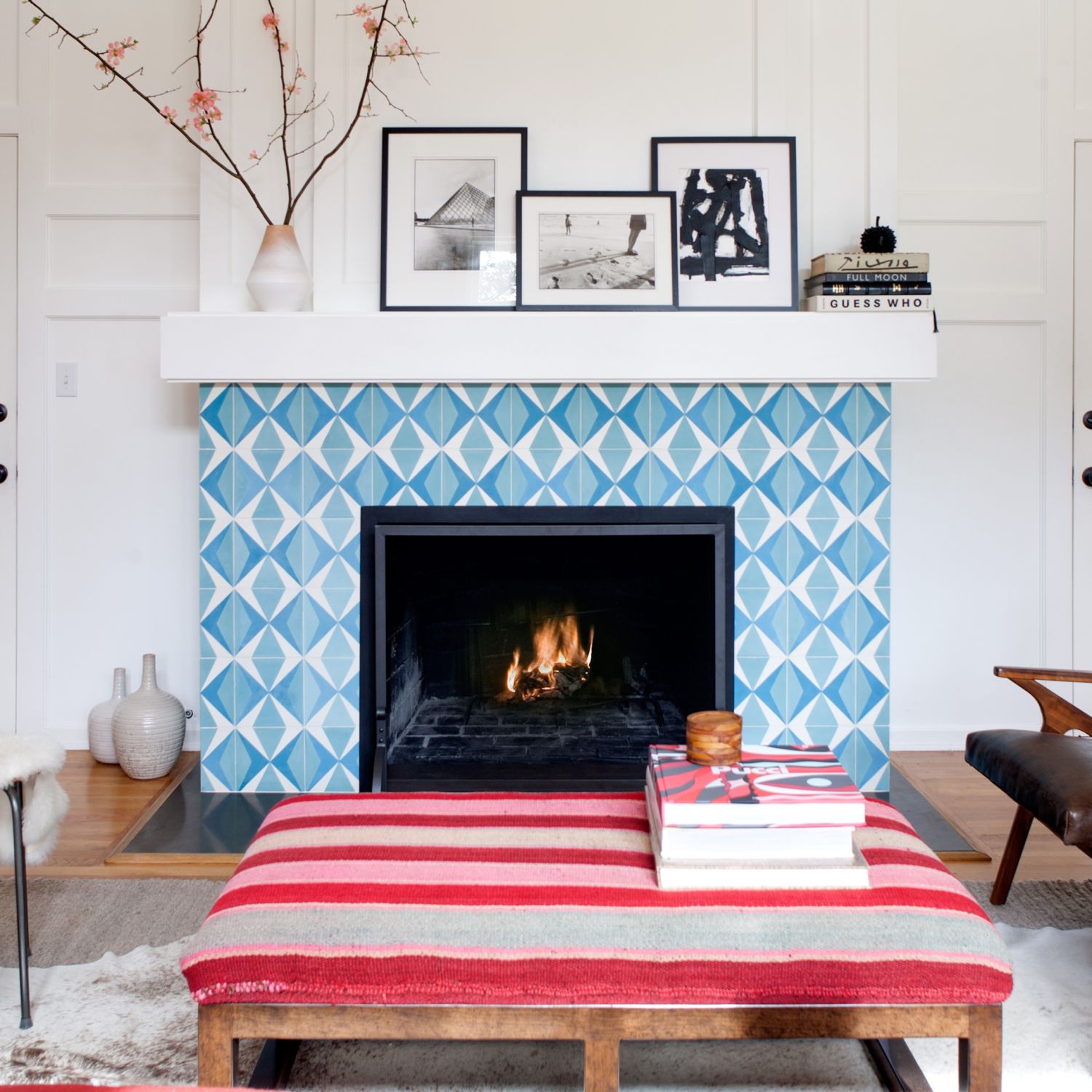 A blue and white tile fireplace in a living room