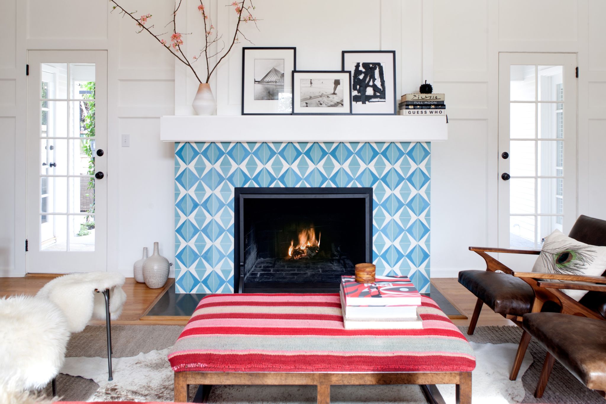 A blue and white tile fireplace in a living room