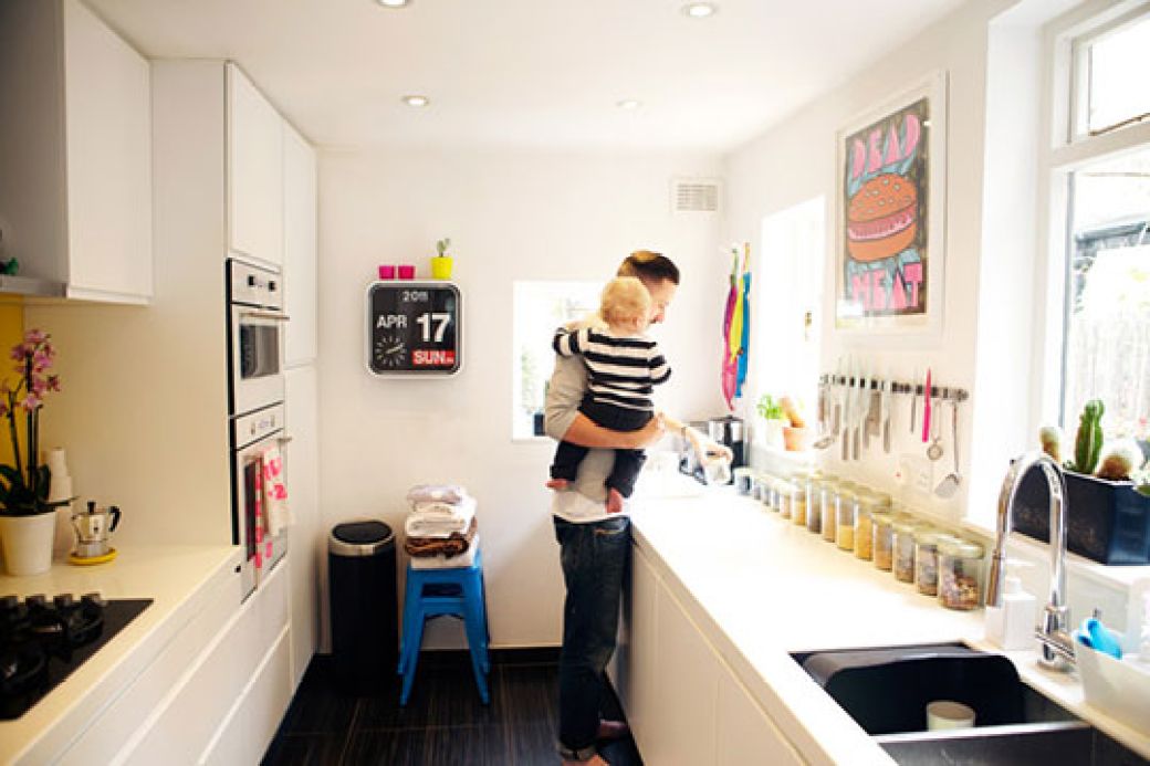 Colorful artwork in white kitchen