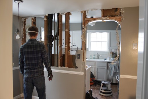 Man demolishing kitchen wall