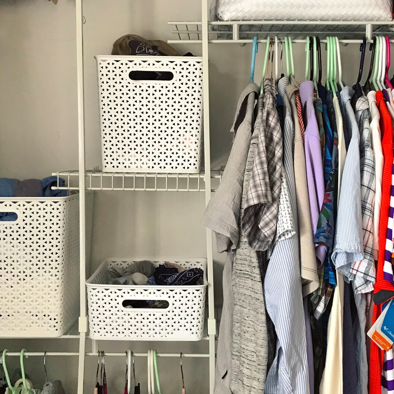 Closet system featuring shirts and four white baskets