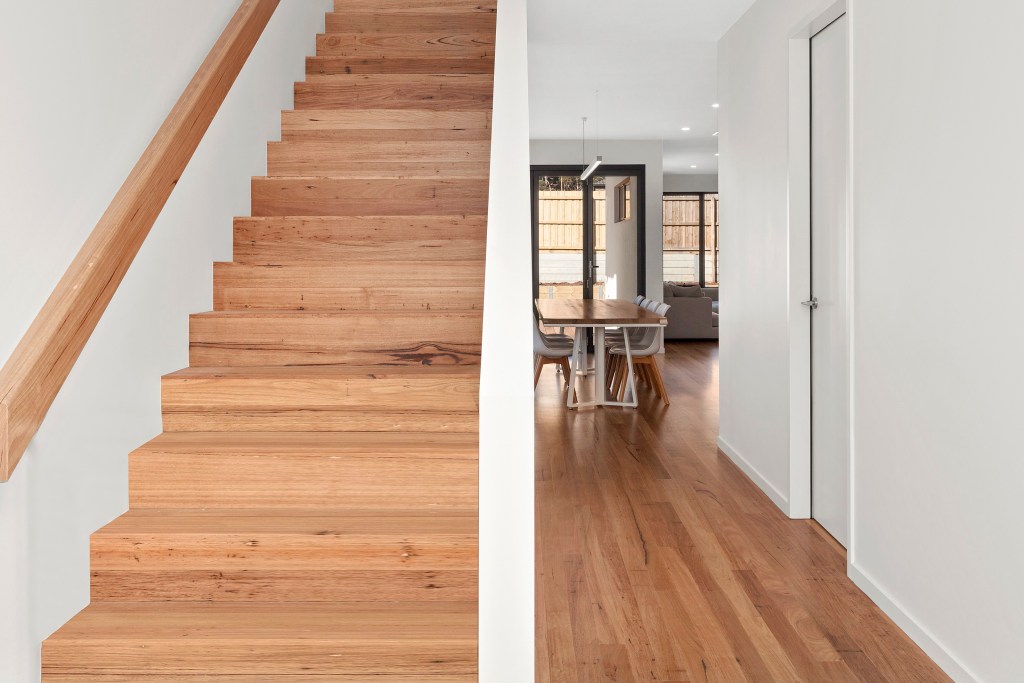 Hardwood floor in a home with flight of stairs