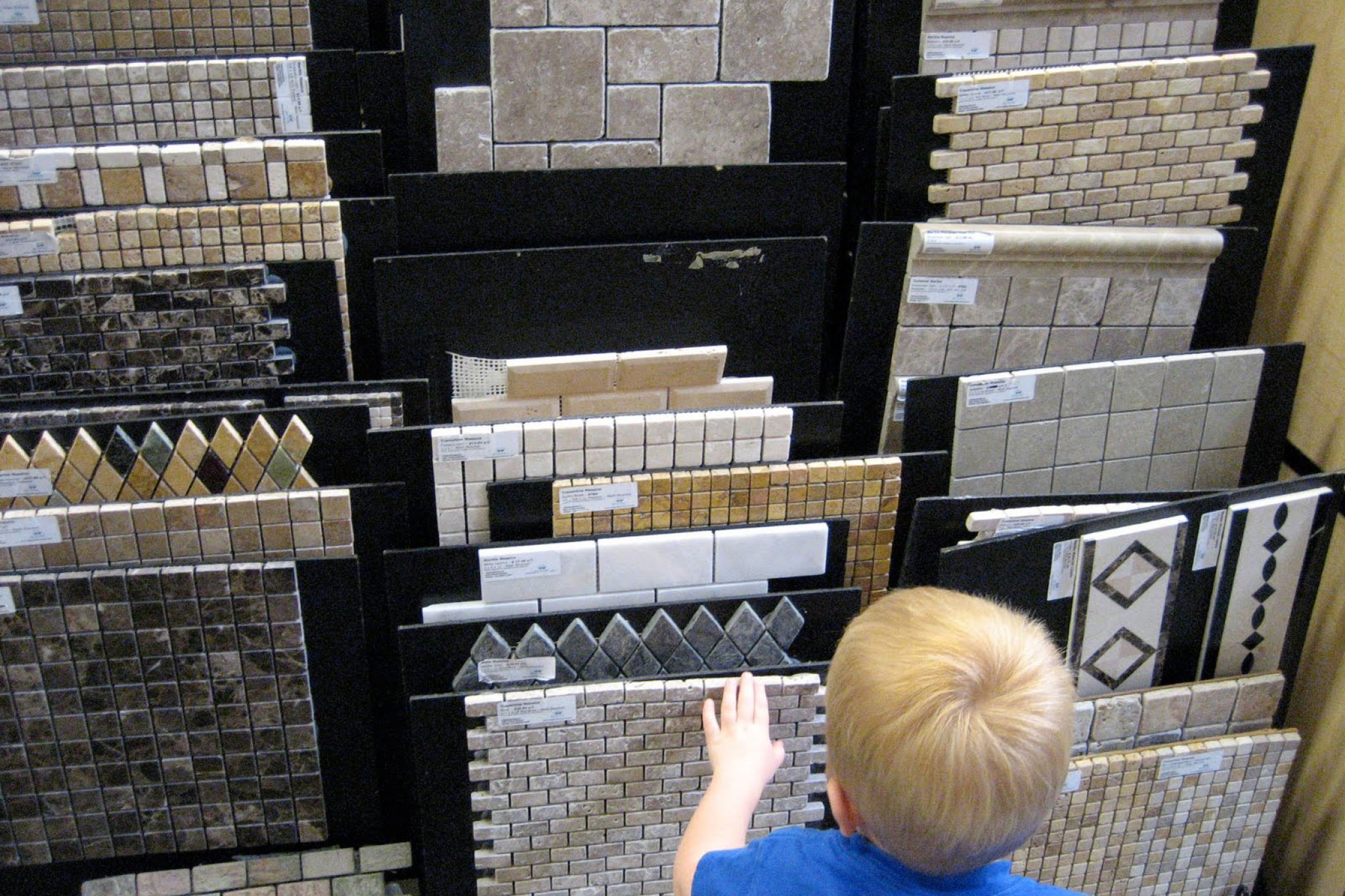 A child looking at tile flooring samples