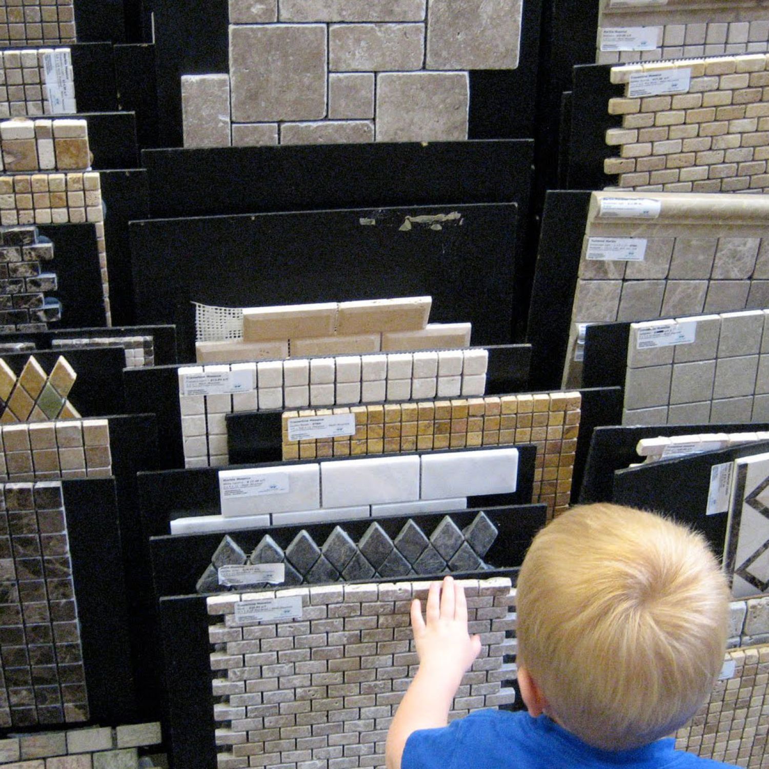 A child looking at tile flooring samples