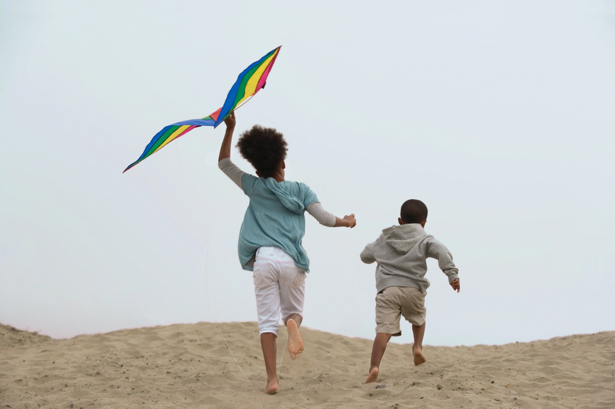 Kids flying kites at the beach