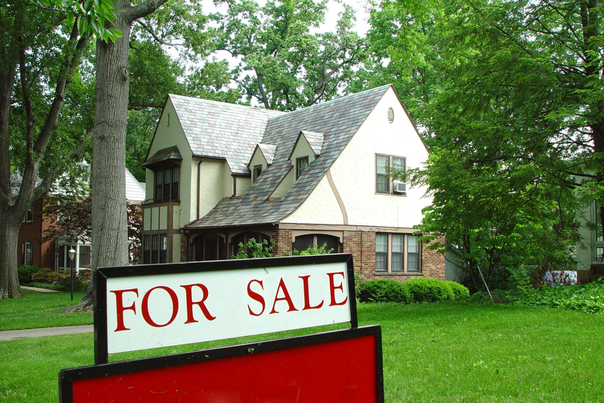 A for sale sign in front of a house