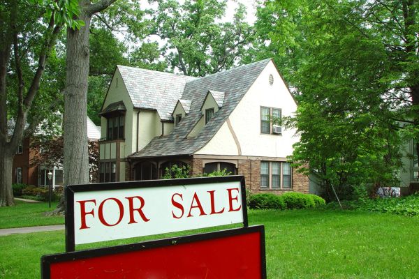 A for sale sign in front of a house