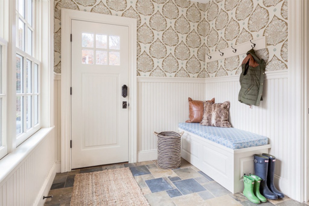 Well-organized mudroom with wainscoting