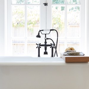 A white clawfoot bathtub in front of closed doors