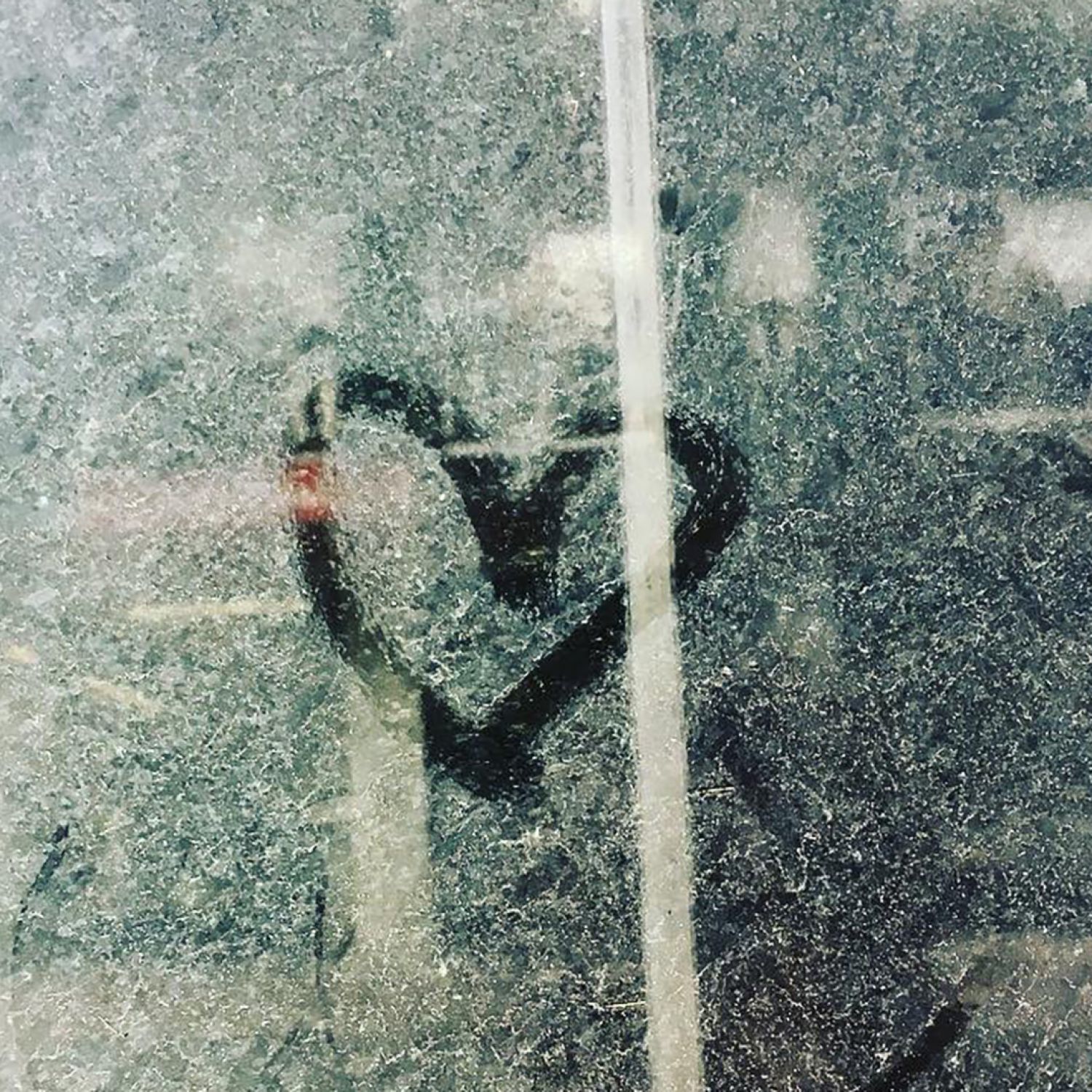 A heart drawn on a dirty, dusty window.