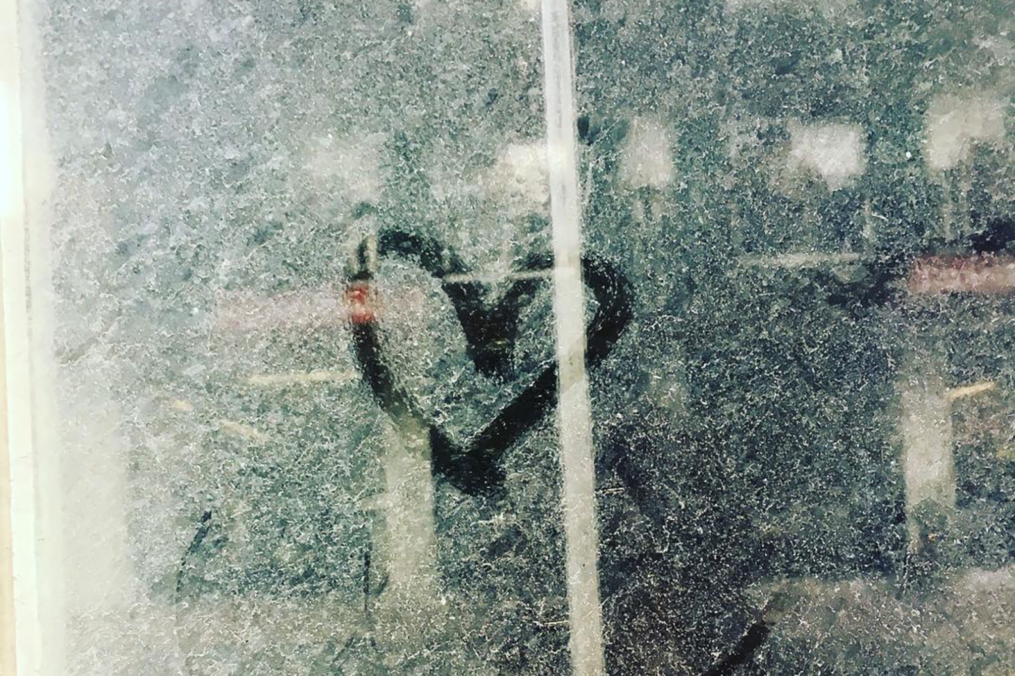 A heart drawn on a dirty, dusty window.