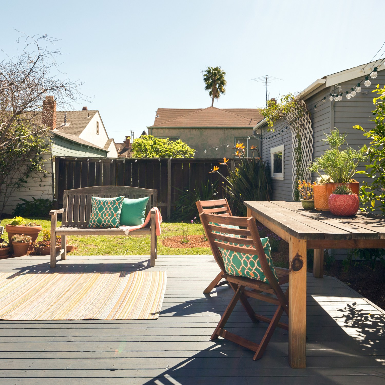 A small patio with furniture and string lights