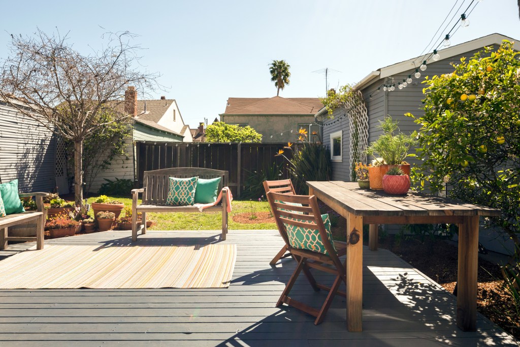 A small patio with furniture and string lights