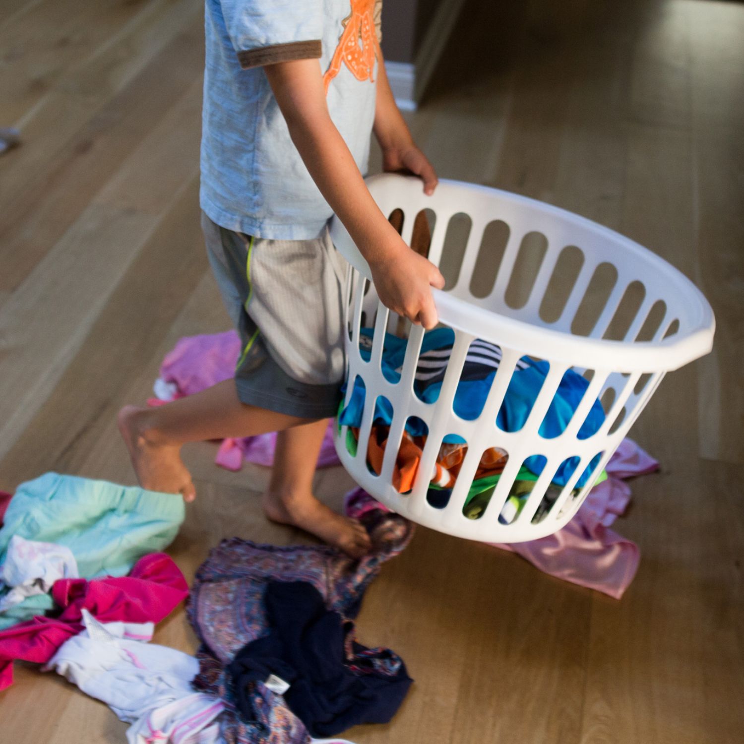 Boy carrying a basket of laundry