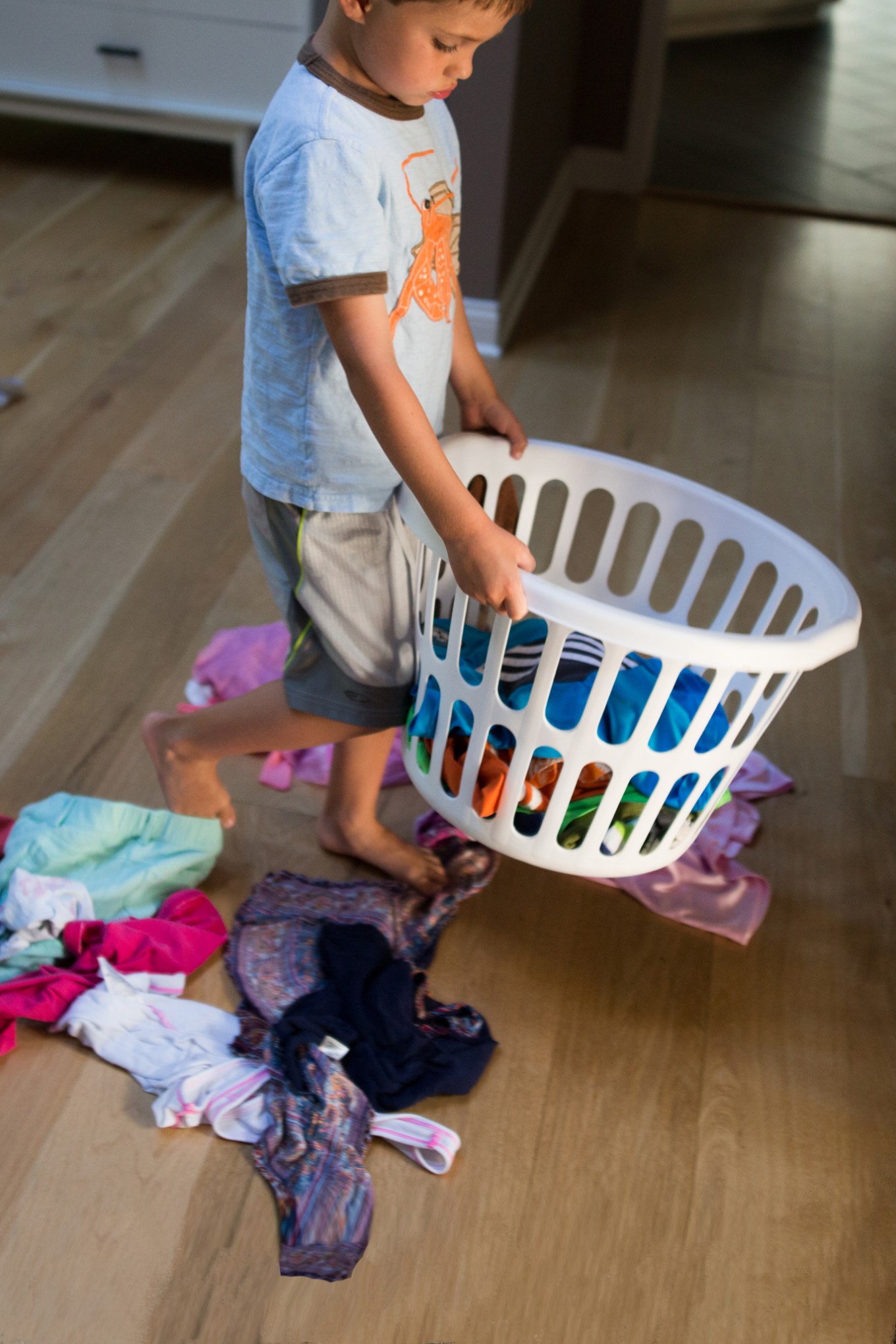 Boy carrying a basket of laundry