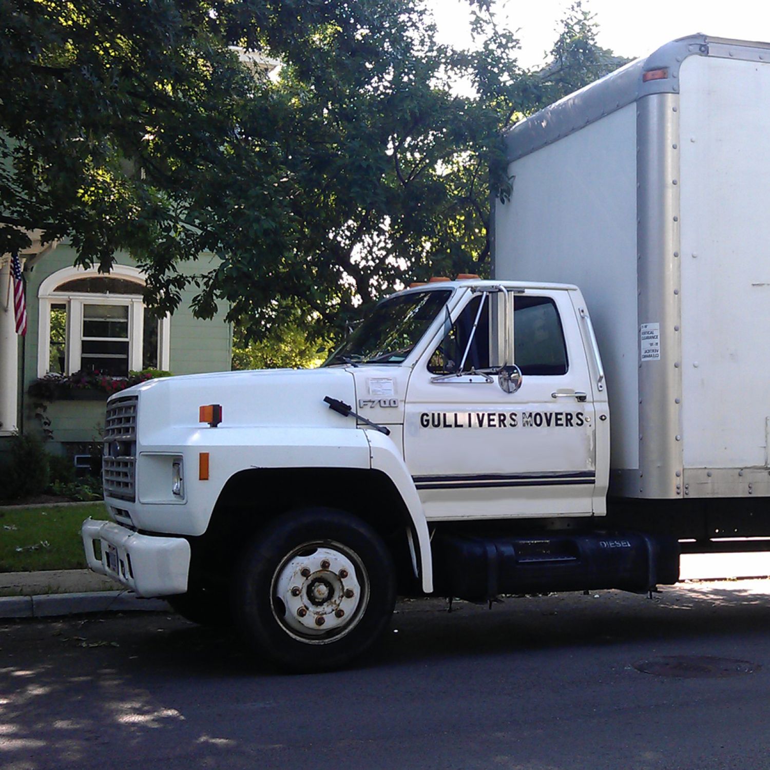 A moving van in front of a house