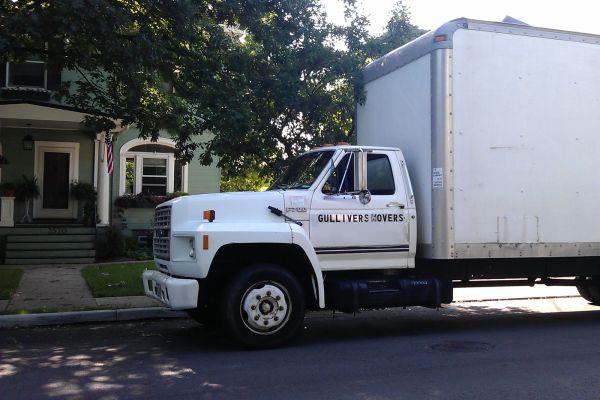 A moving van in front of a house