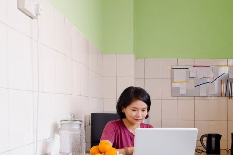 Penny-pinching woman in her kitchen