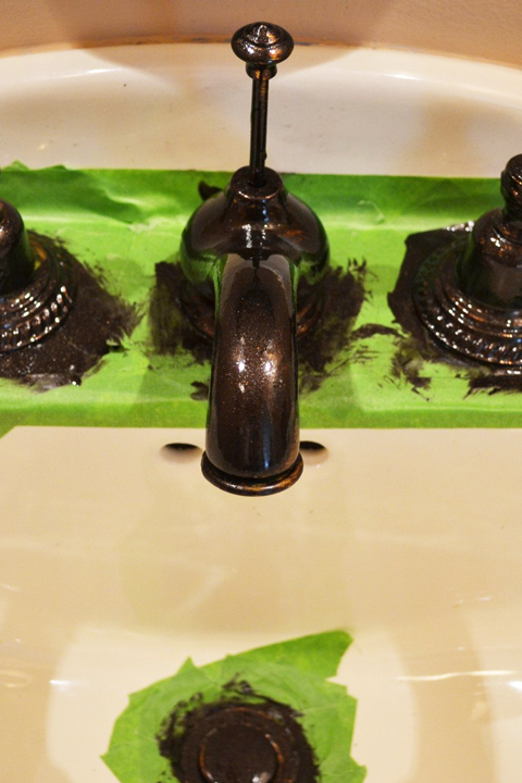 Black painted fixtures with green tape in bathroom