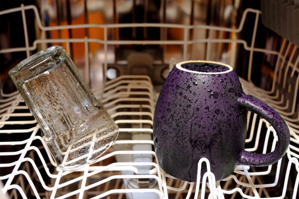 Inside of a wet dishwasher with few items inside