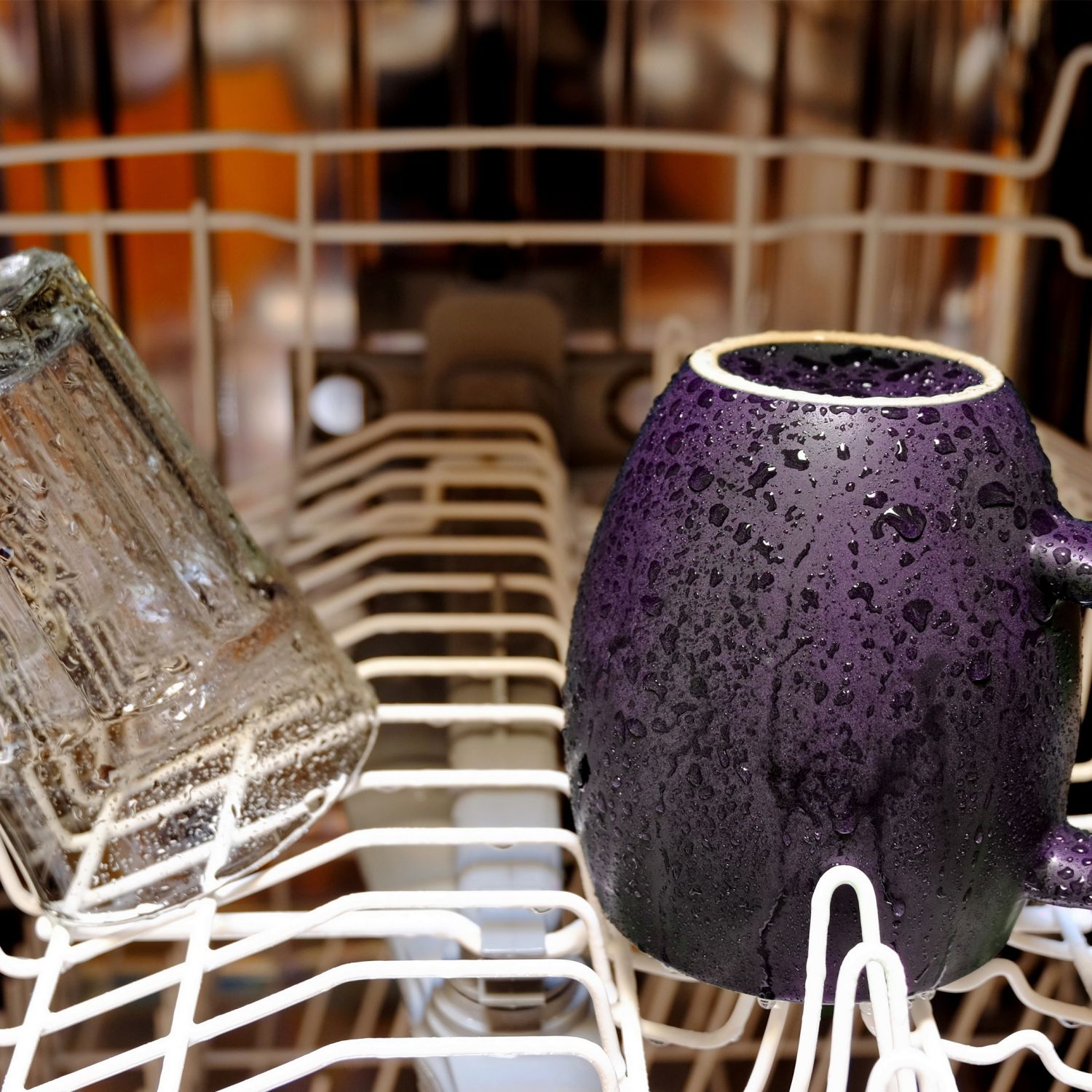 Inside of a wet dishwasher with few items inside