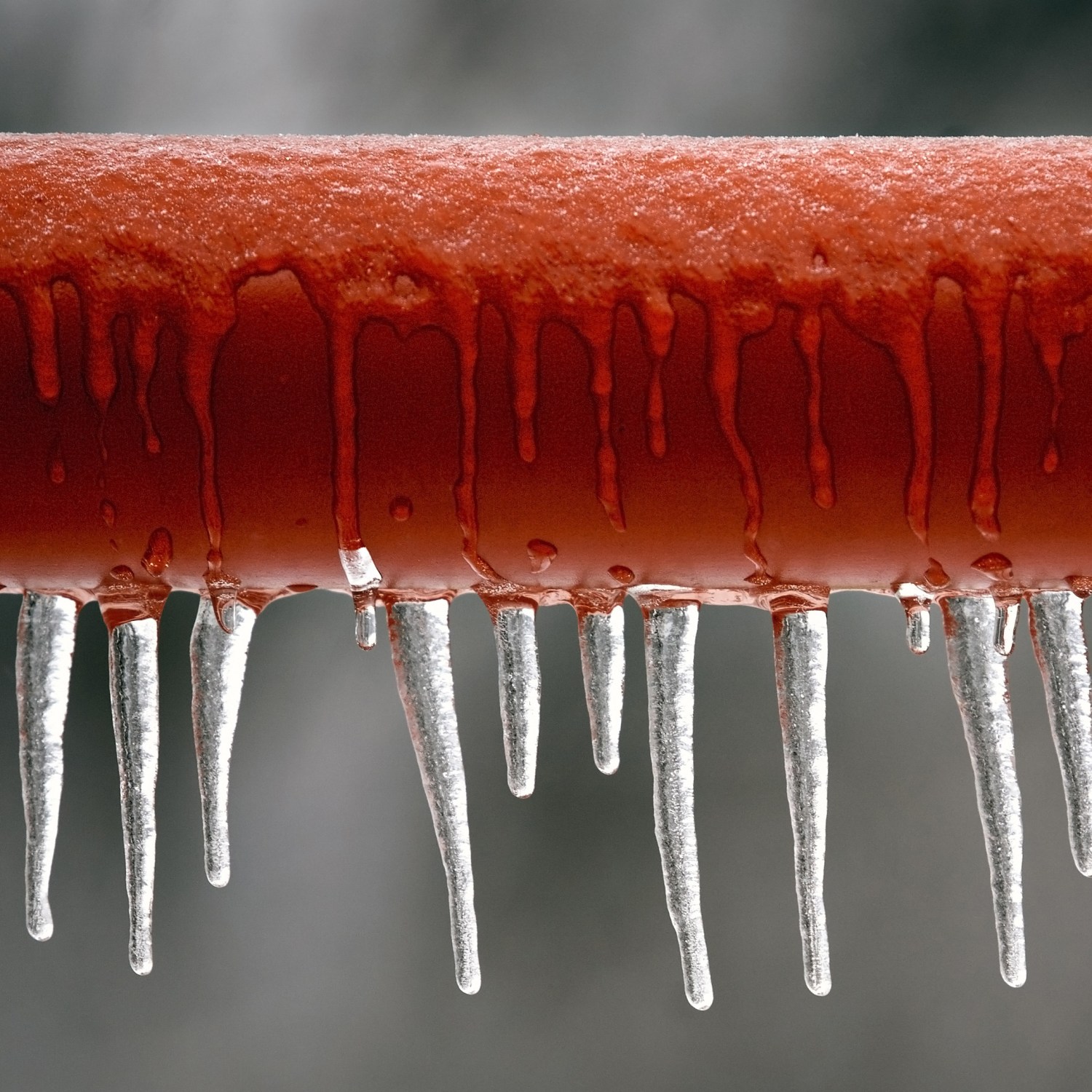 red frozen pipe with icicles in a home