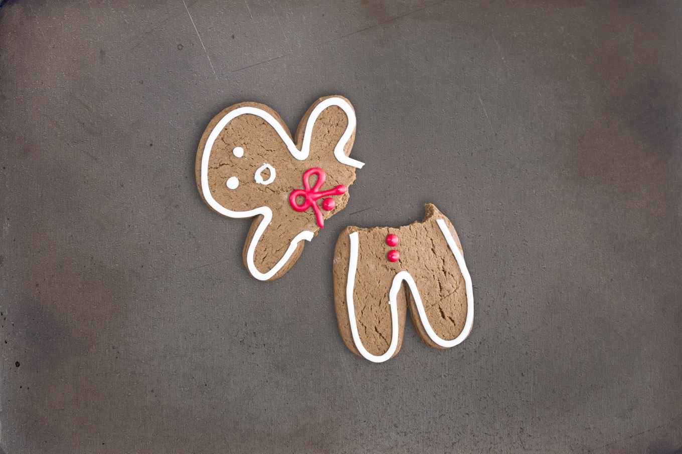 Broken gingerbread cookie on baking tray