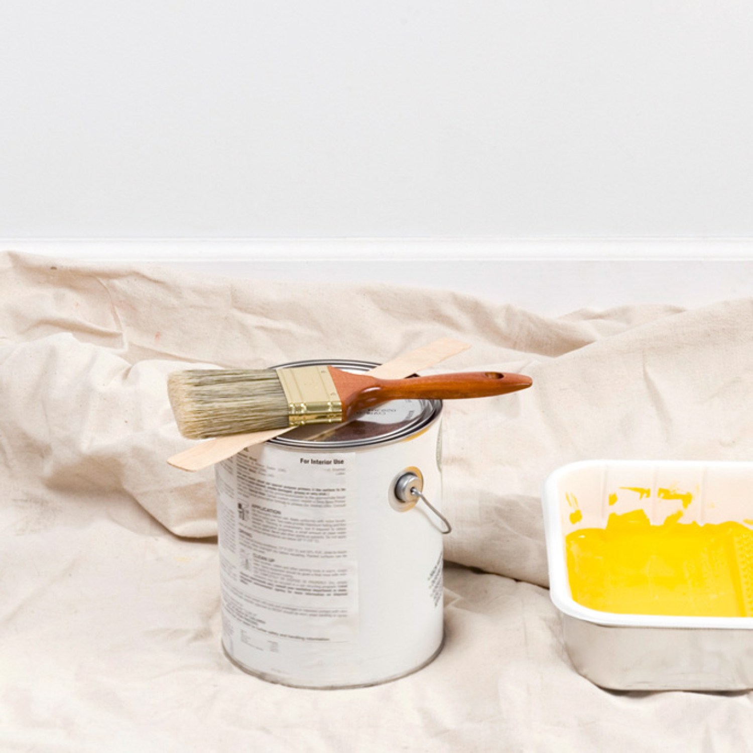 Painting supplies and yellow wall paint