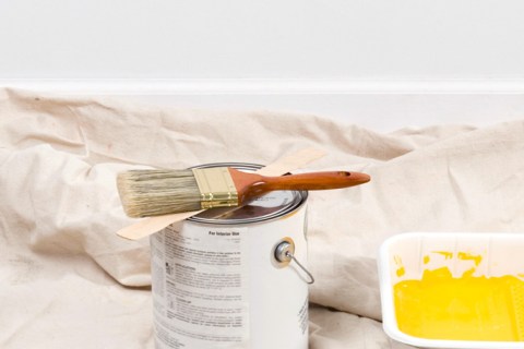 Painting supplies and yellow wall paint