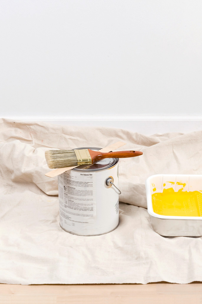 Painting supplies and yellow wall paint