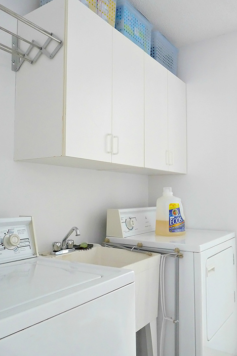 White washer and dryer with with white cabinets