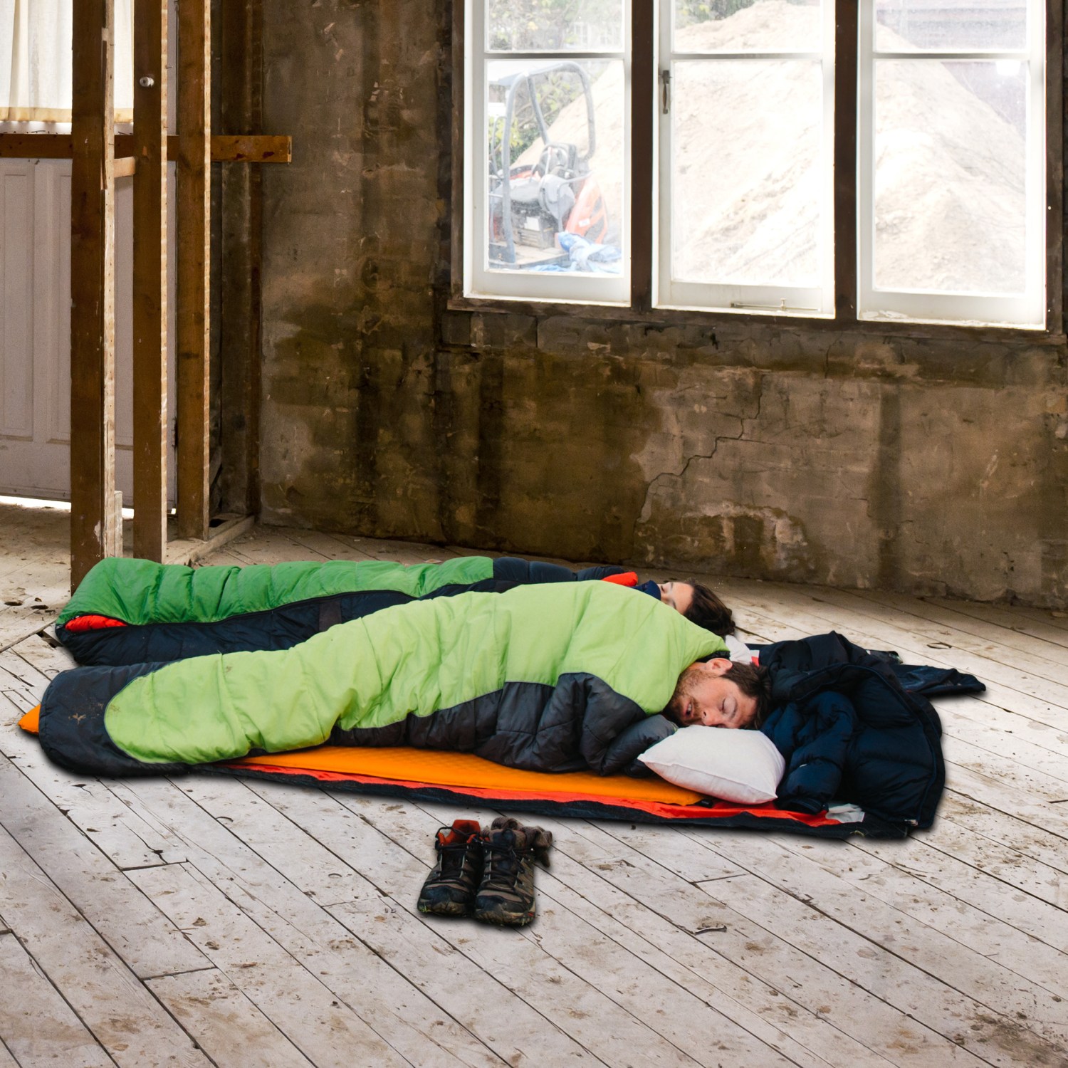 Couple in sleeping bags during home renovation