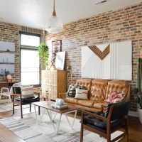 Bright living room with brick walls and wood floors