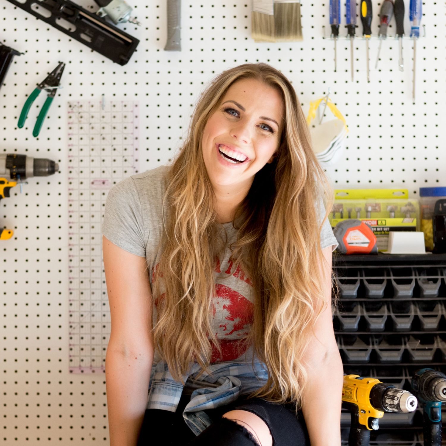 Mandi Gubler sitting on a work bench