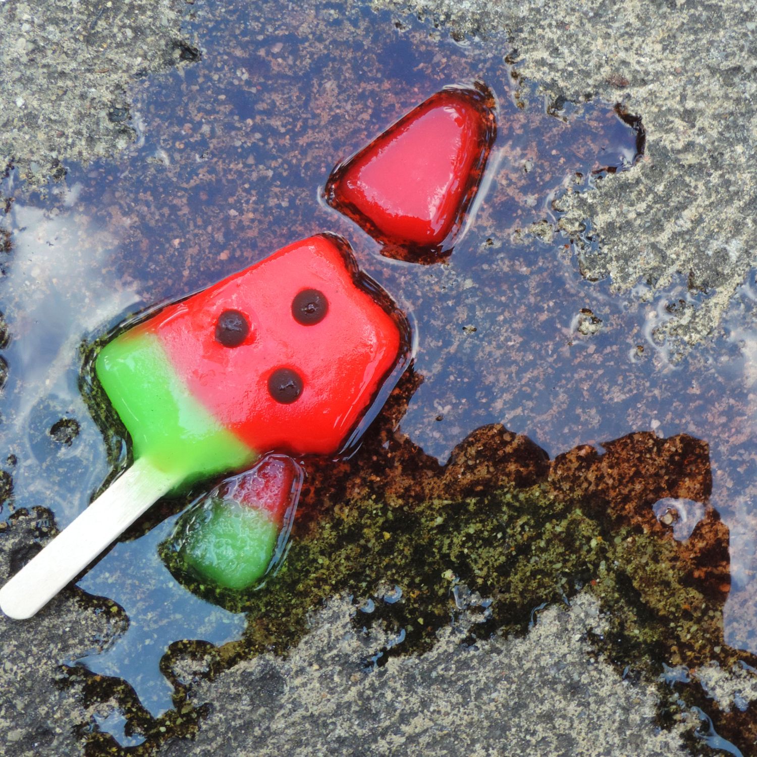 Melting popsicle on the sidewalk