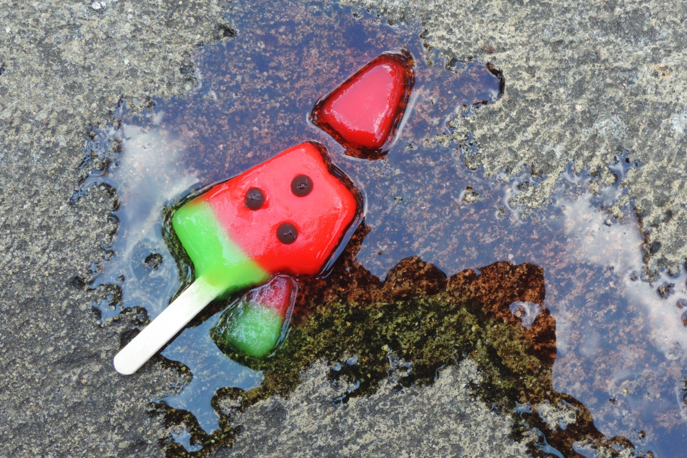 Melting popsicle on the sidewalk