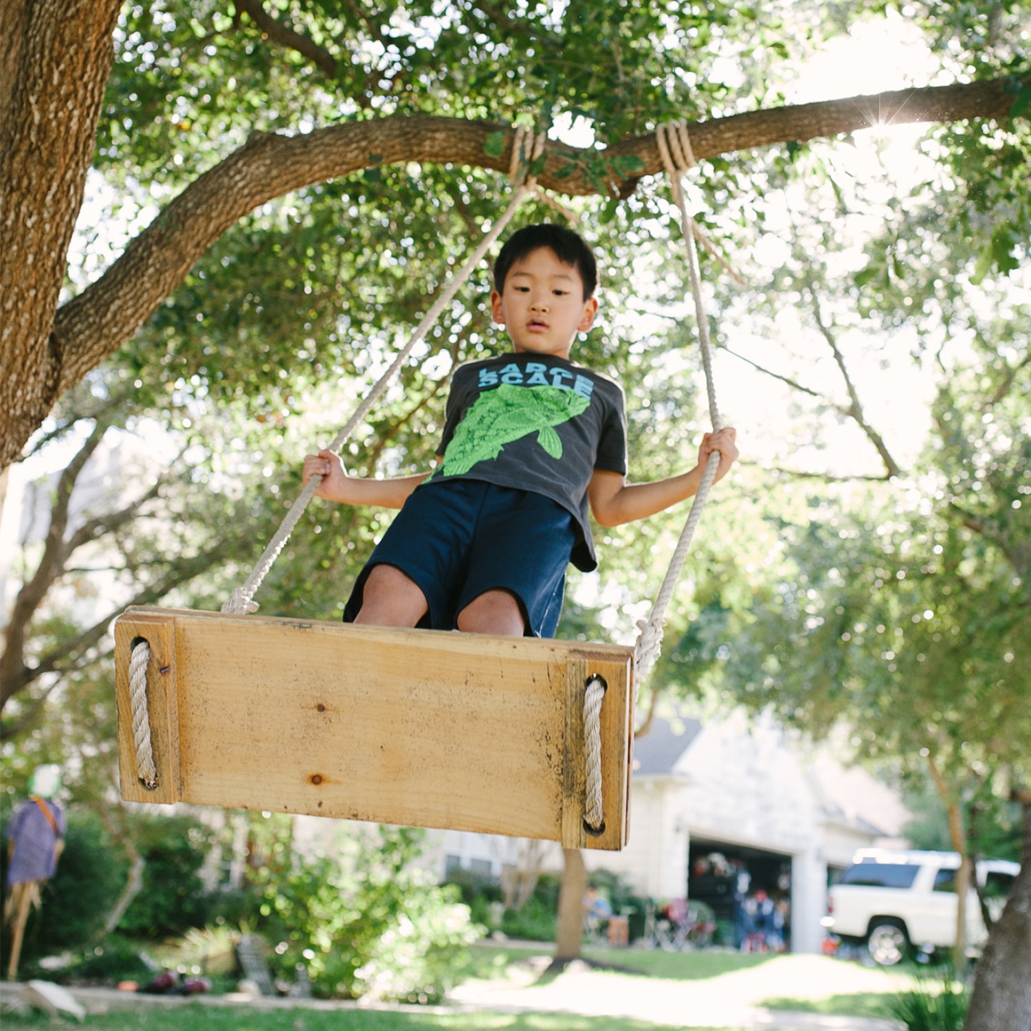 Boy on a rope swing outside