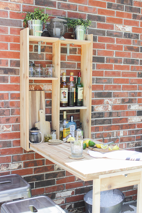 Open wood murphy bar on a brick wall with gray stools