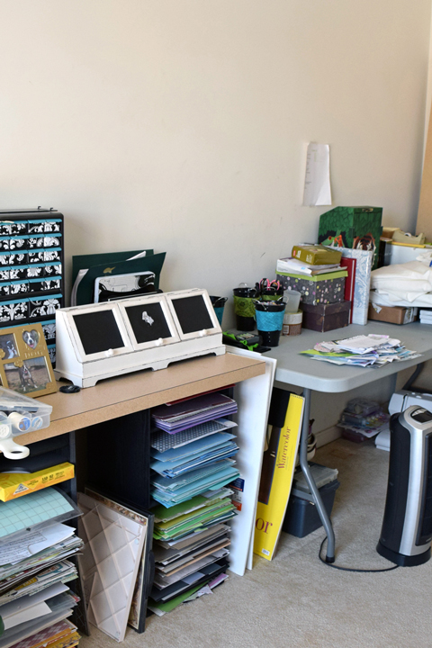 Messy craft room with plastic table, bookshelf, chair