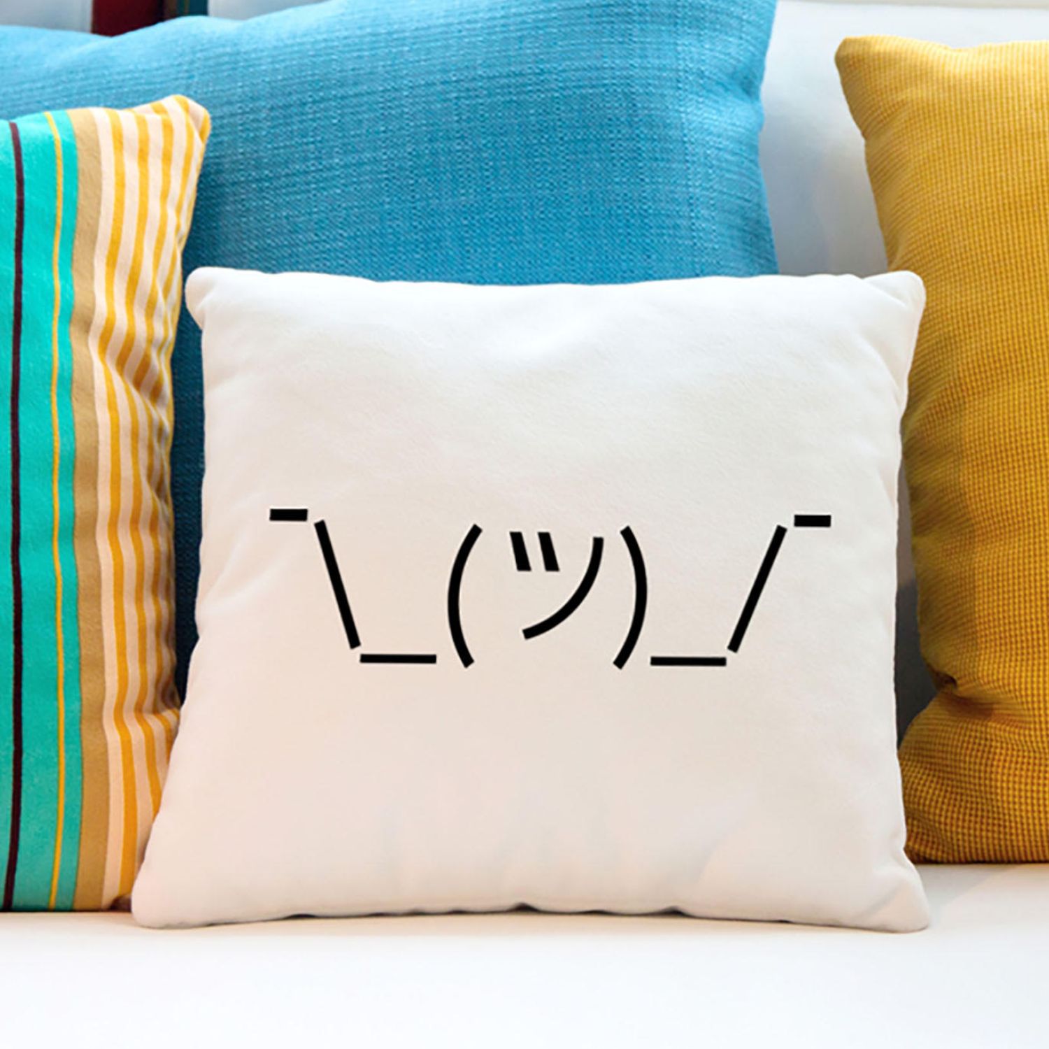 Shrugging emoji on a throw pillow