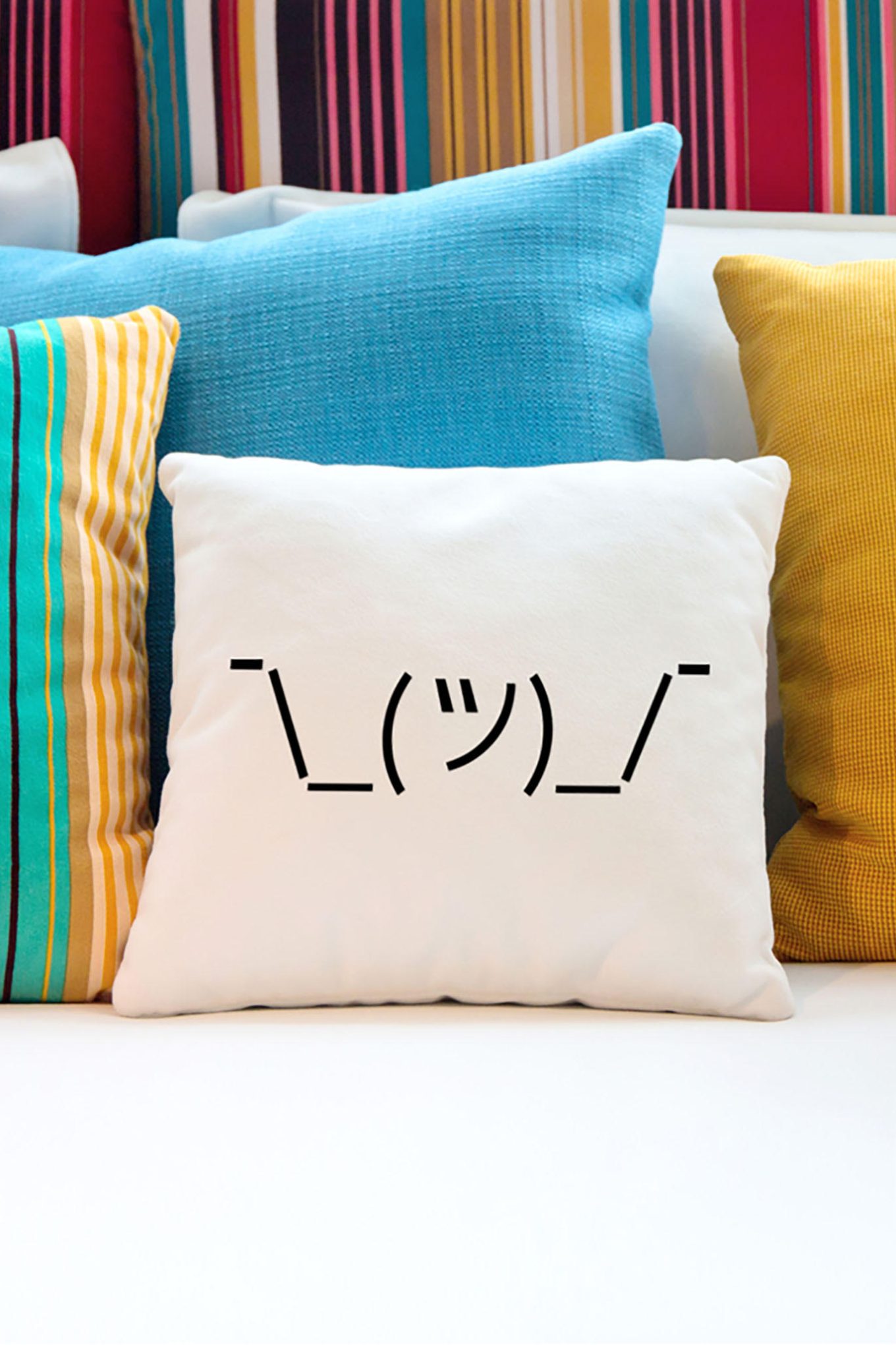 Shrugging emoji on a throw pillow