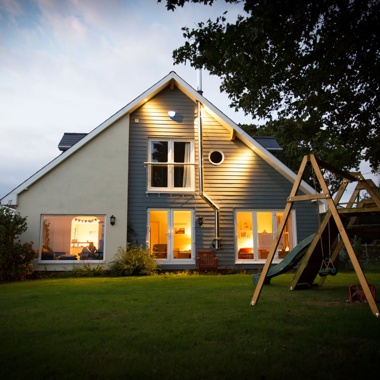 House with swing set illuminated at night | Prevent Burglary