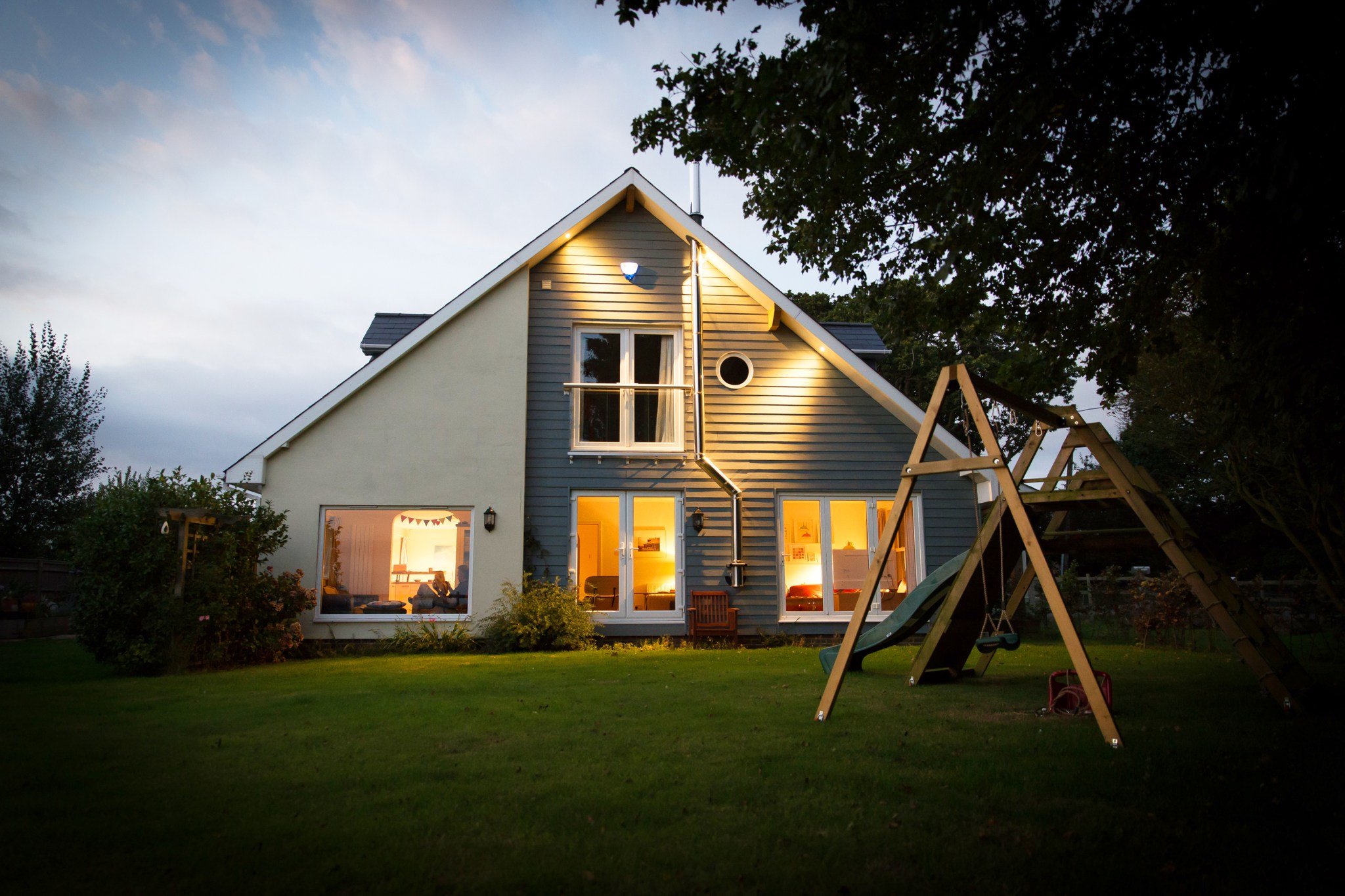 House with swing set illuminated at night | Prevent Burglary